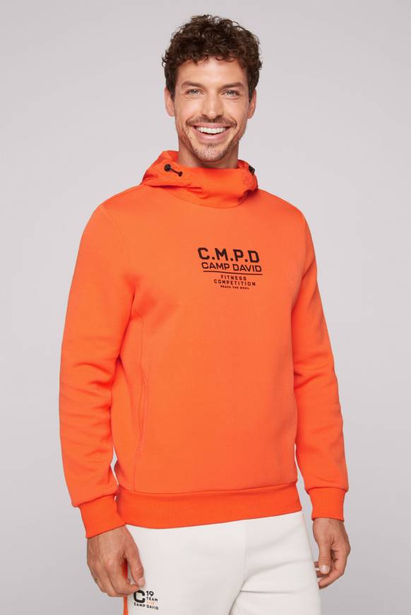 Soccx Hoodie im Materialmix mit Artwork und Rückentasche signal orange